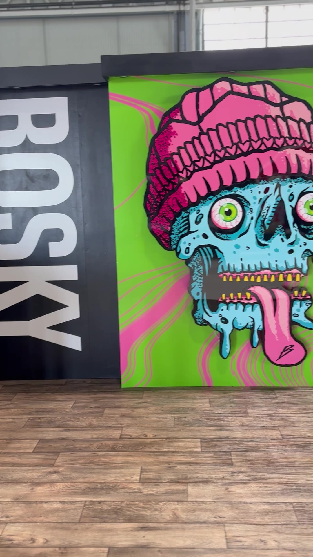 BOSKY back-wall logo meeting the skull mural