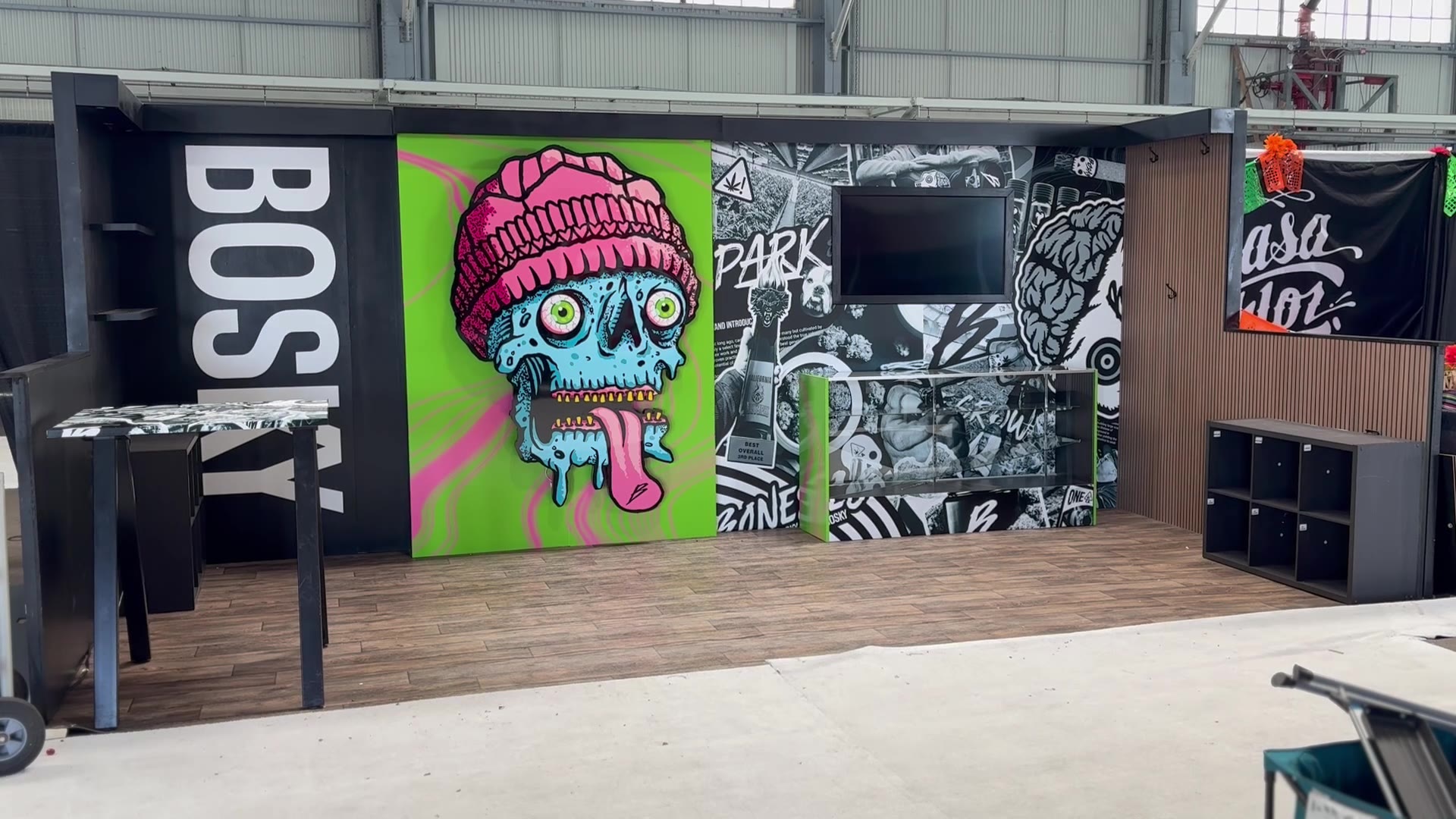 Wide view of the 10×20 booth — mural walls, display case and custom soffit