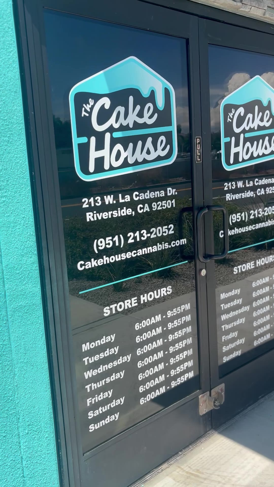 Front door — logo decals, address and store hours on glass